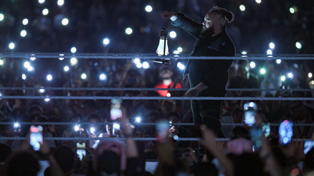 Bray Wyatt is lit by all the phone lights in the arena.