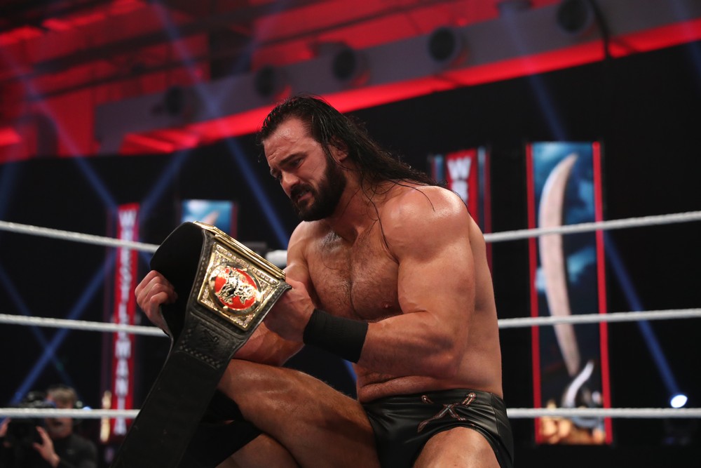 Drew McIntyre gazes into the WWE Championship title belt after beating Brock Lesnar at WrestleMania 36. WWE photo