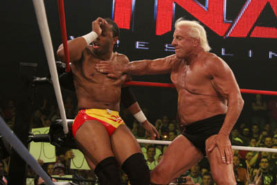 Ric Flair chops Jay Lethal.