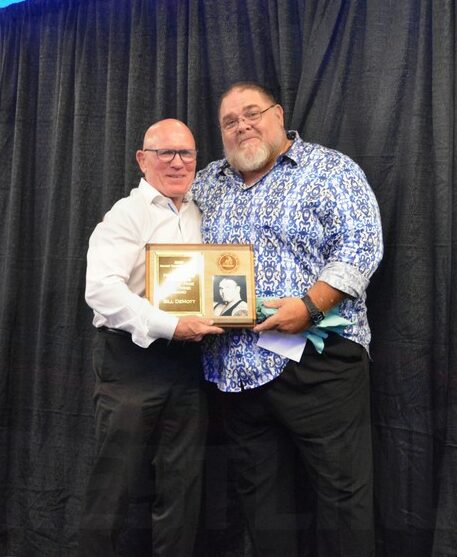 Museum Director Jim Miller and Bill DeMott with his Lou Thesz Award at the Tragos/Thesz Professional Wrestling Hall of Fame induction on Saturday, July 22, 2023, in Waterloo, Iowa. Photo by Joyce Paustian