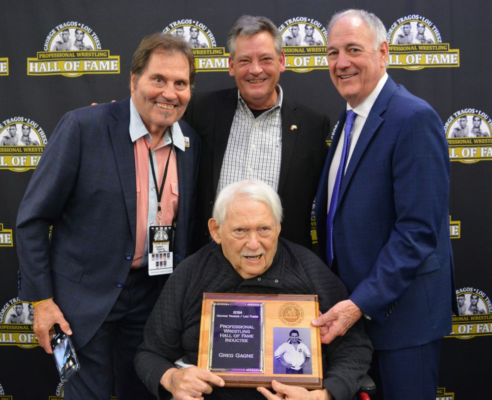 Al Rusha, holding Greg Gagne's induction plaque, with Jim Brunzell, Gary DeRusha and Greg Gagne, at the Tragos/Thesz Professional Wrestling Hall of Fame induction at the Dan Gable Museum in Waterloo, Iowa, in July 2024. Photo by Joyce Paustian