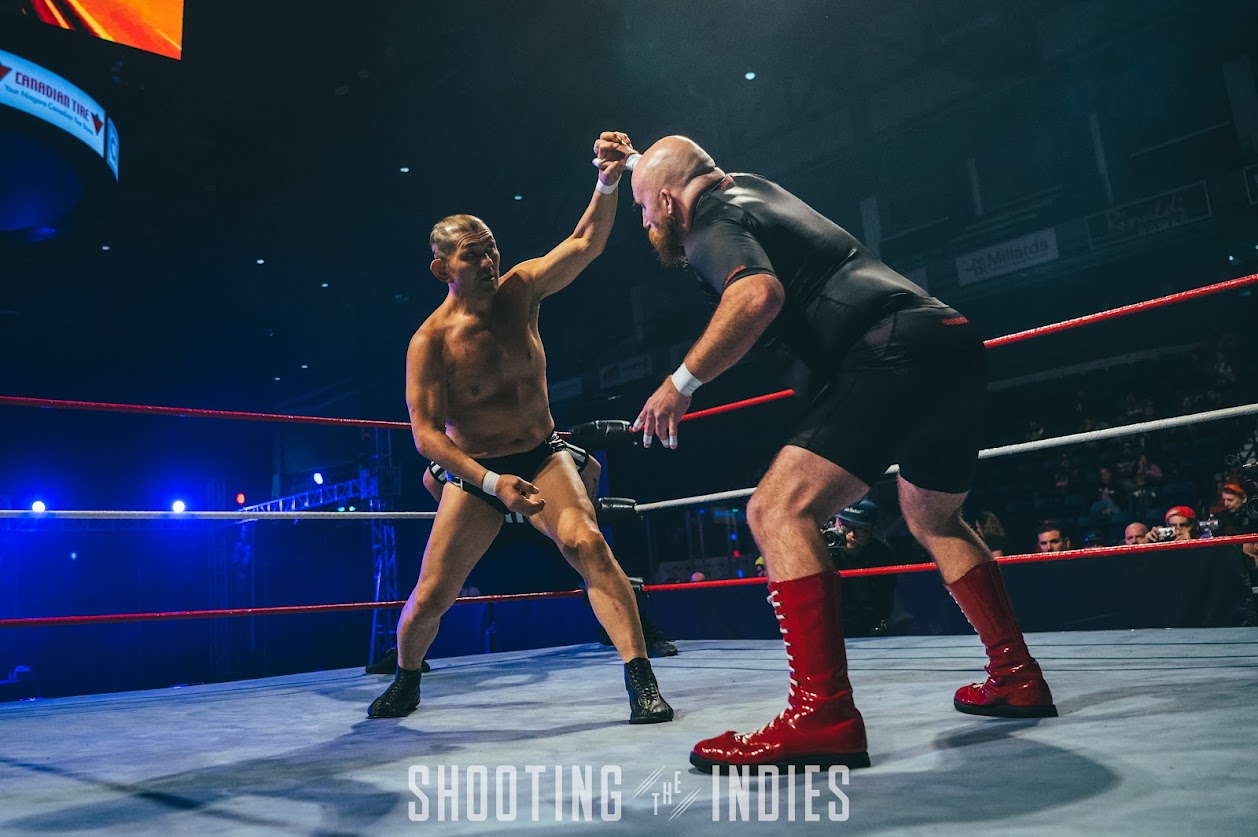 Jeremy Elliott shares the ring with Minoru Suzuki. Photo by Shooting the Indies.