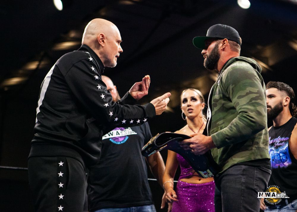 Billy Corgan is handed the NWA World Heavyweight title by an injured Matt Cardona on June 11, 2022, at the Alwayz Ready PPV. Photo by Hiban Huerta/NWA