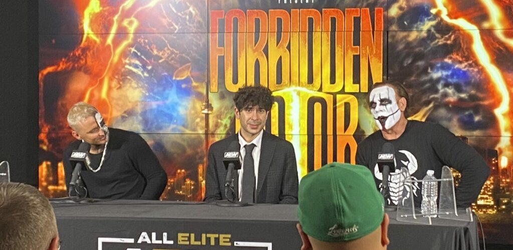 Sting, Darby Allin, and Tony Khan seated at the AEW Forbidden Door post-show media scrum at Scotiabank Arena in Toronto.