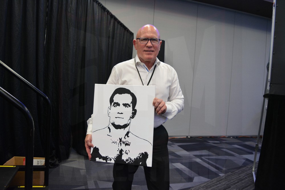 Museum Director Jim Miller with new Lou Thesz artwork at the Tragos/Thesz Professional Wrestling Hall of Fame induction on Saturday, July 22, 2023, in Waterloo, Iowa. Photo by Joyce Paustian