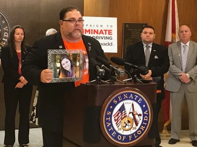 Bill DeMott holds a photo of his daughter, Keri Anne, killed on October 10th, 2015, while at a speaking engagement. Photo courtesy The Keri Anne DeMott Foundation
