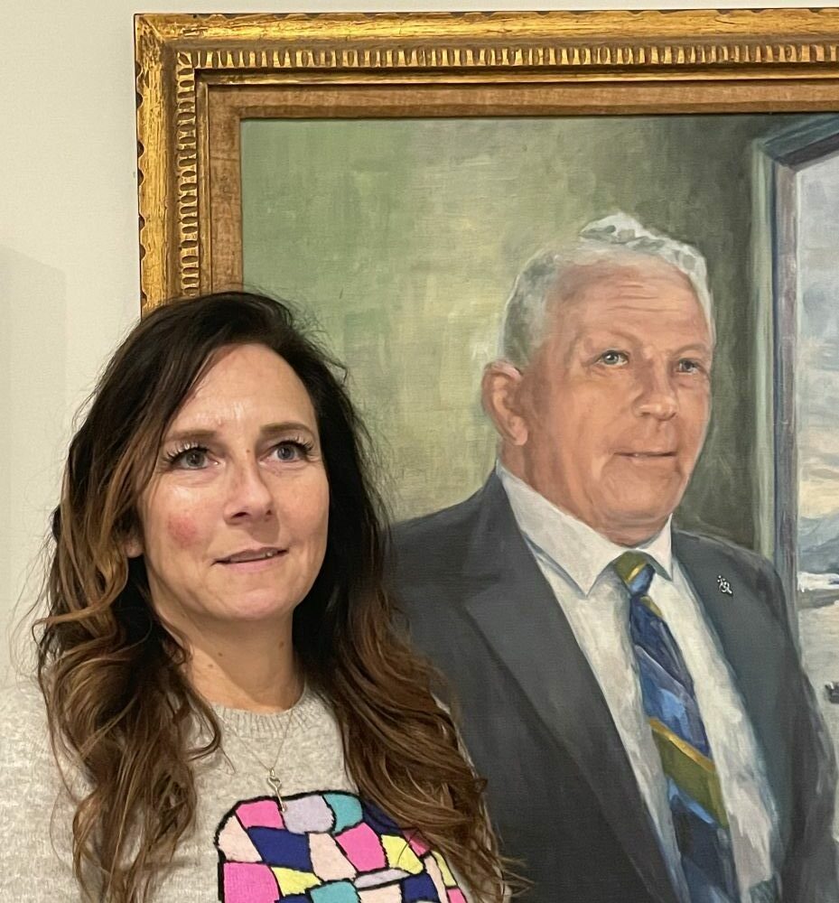 Jodi Williams stands beside a painting of her grandfather, Milo Steinborn. Photo courtesy Jodi Williams