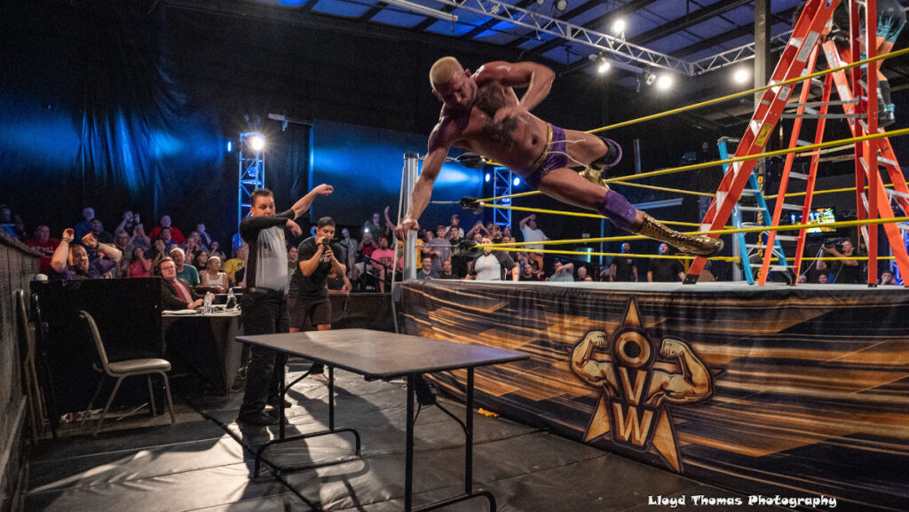 Luke Kurtis goes off a ladder and through a table at OVW. Photo by Lloyd Thomas.