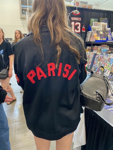 Tony Parisi's granddaughter shows off his warm-up jacket. Photo by Caleb Smith