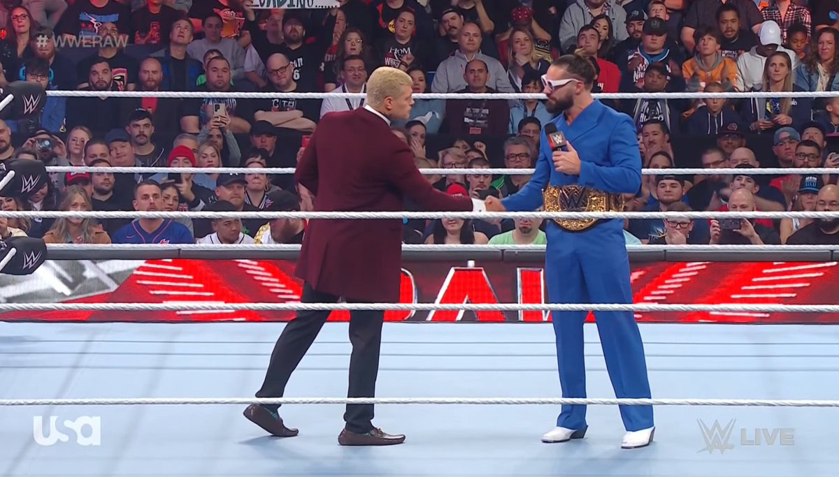Cody Rhodes shakes hands with Seth Rollins.