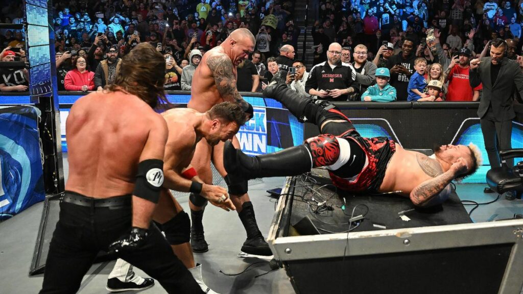 AJ Styles, LA Knight and Randy Orton attack Solo Sikoa. WWE photo