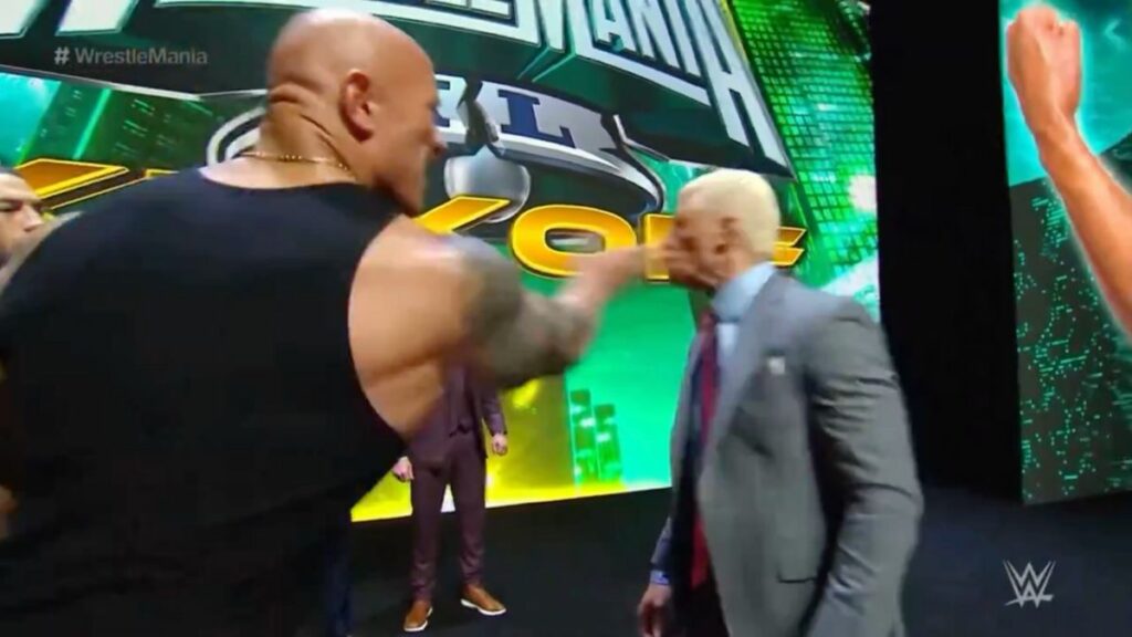 The Rock slaps Cody Rhodes.