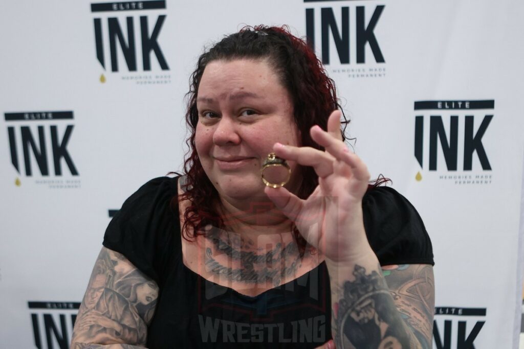 Andre the Giant's daughter Robin Roussimoff with his father's WWE Hall of Fame size 16 ring at The Big Event fan fest on Saturday, March 16, 2024, at the Suffolk Credit Union Arena in Brentwood, NJ. Photo by George Tahinos, https://georgetahinos.smugmug.com