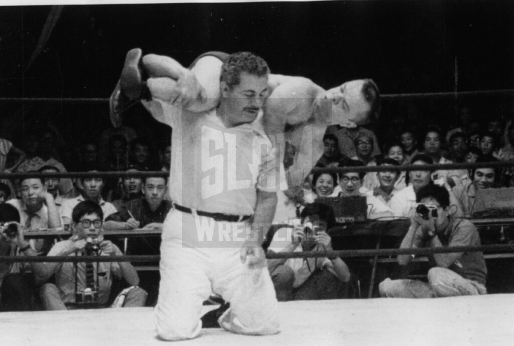 Jack Britton, the father of Gino Brito, referees a midget match in Japan.
