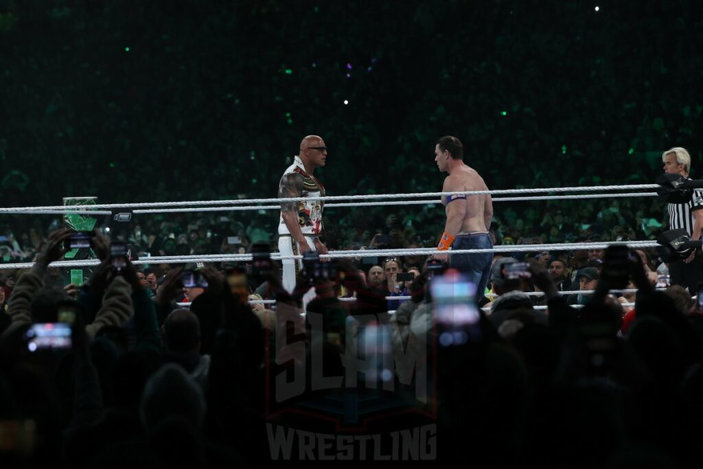 The Rock and John Cena face off during the Undisputed WWE Universal Championship match between Roman Reigns (c) and Cody Rhodes at Night 2 of WrestleMania XL at Lincoln Financial Field in Philadelphia, PA, on Sunday, April 7, 2024. Photo by George Tahinos, georgetahinos.smugmug.com