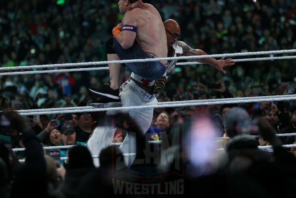 The Rock and John Cena face off during the Undisputed WWE Universal Championship match between Roman Reigns (c) and Cody Rhodes at Night 2 of WrestleMania XL at Lincoln Financial Field in Philadelphia, PA, on Sunday, April 7, 2024. Photo by George Tahinos, georgetahinos.smugmug.com