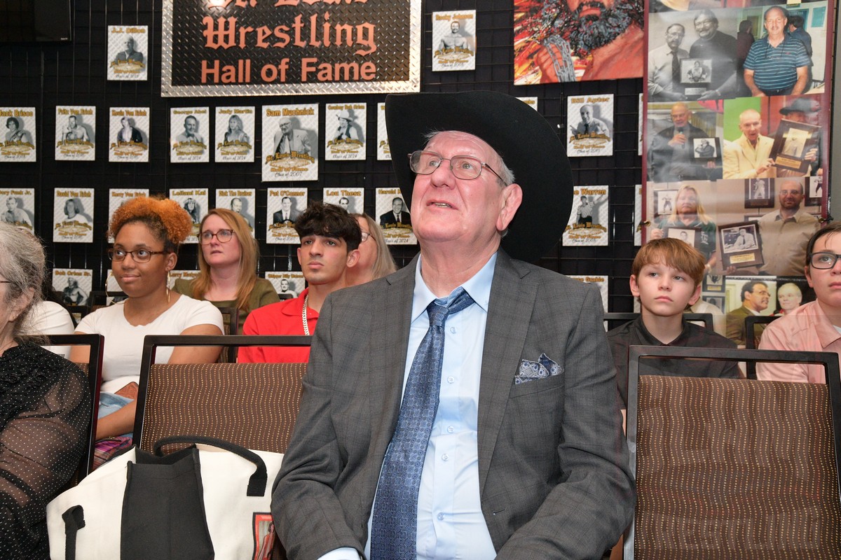 Cowboy Bob Orton listens to his children talk about him at the St. Louis Wrestling Hall of Fame induction at the SICW Fan Fest II at the Aviator Hotel in St. Louis, on Saturday, May 18, 2024. Photo by Scott Romer