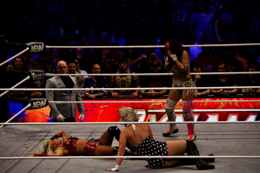 Mina Shirakawa is in disbelief after knocking out Mariah May with a champagne bottle intended for AEW Women's World Champion "Timeless" Toni Storm at AEW Dynamite at the Keybank Center in Buffalo, NY on June 26, 2024. Photo by Steve Argintaru, Twitter/IG: @steven