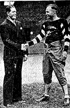 Mayes McLain shakes hands with Lionel Conacher.