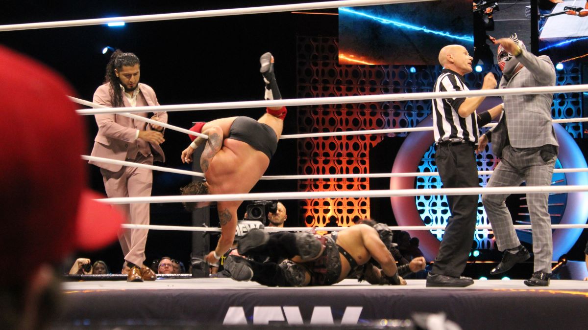 Beef gets tripped up by Rush (left) and gets sent tumbling down to the mat at AEW Rampage, taped at the Maverik Center in Salt Lake City, Utah, on Wednesday, October 23, 2024. Photo by Tommy "Milagro" Martinez