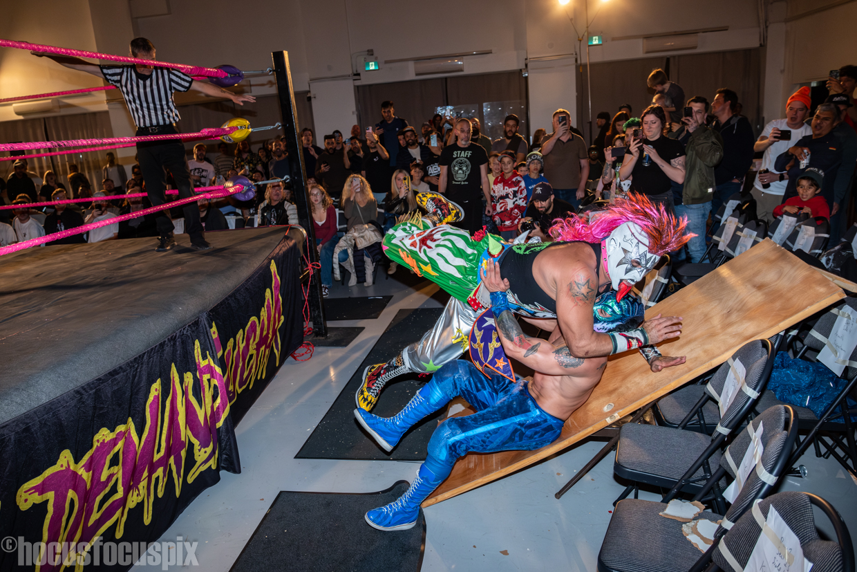 Psycho Clown dives onto Lince Dorado at Demand Lucha’s “Lucha de los Muertos” on Thursday, October 17, 2024, at Parkdale Hall in Toronto, Ontario. Photo by John Gallant / @hocusfocuspix