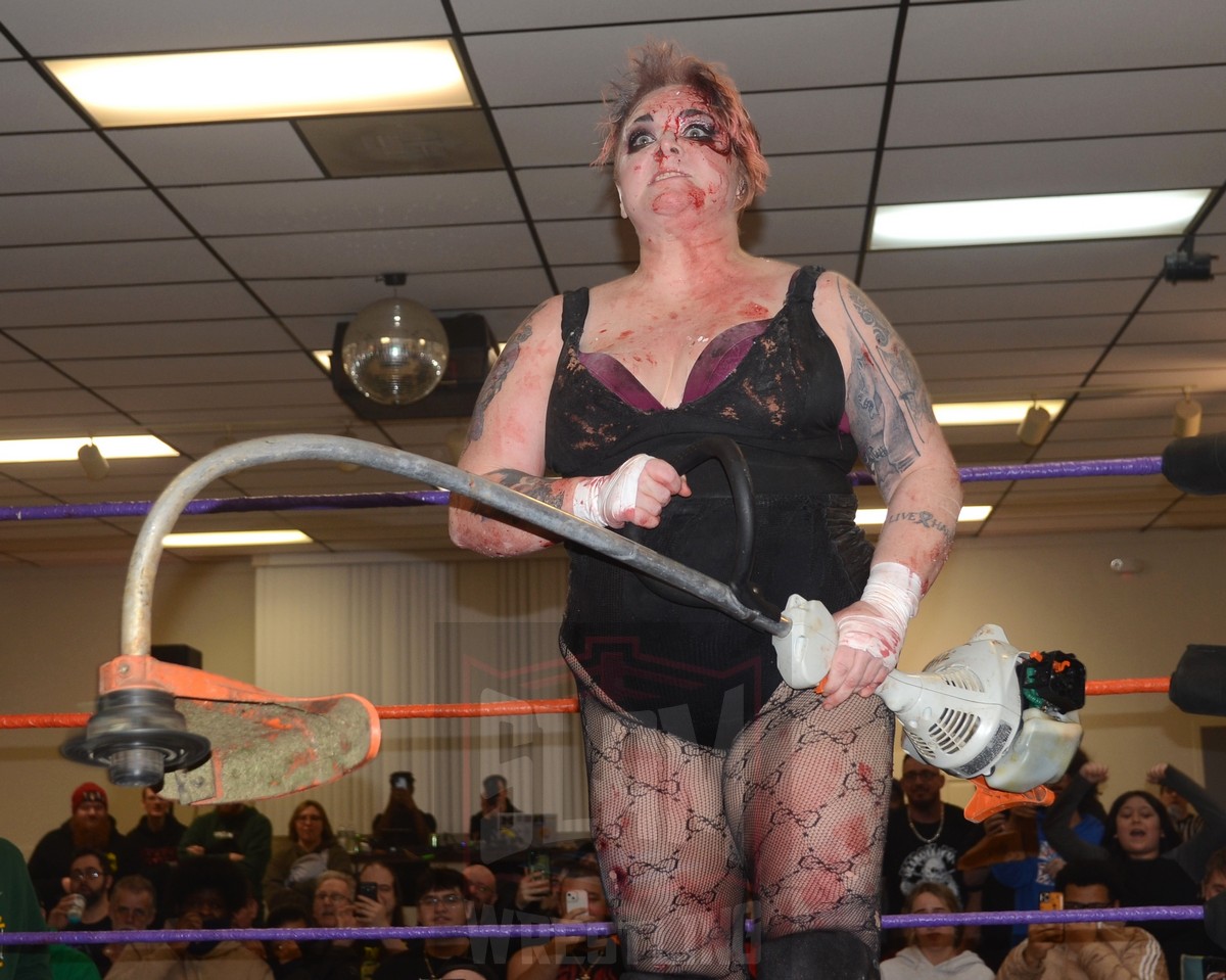 Mickie Knuckles brandishing a Weed-Wacker during a match on January 5, 2024. Photo by Brad McFarlin