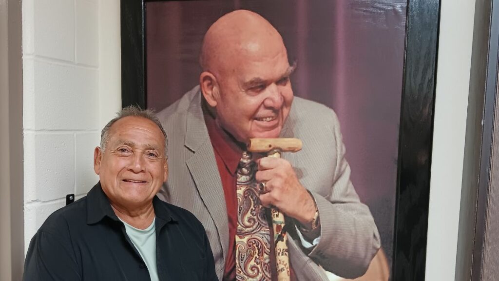 Berney Gonzales with photo of George Steele